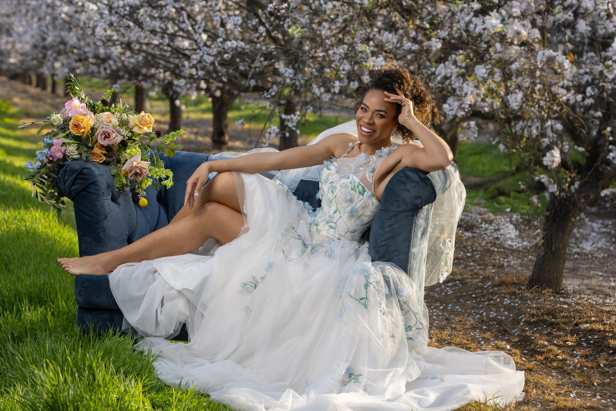 A spring bride on a couch situated on a flower farm