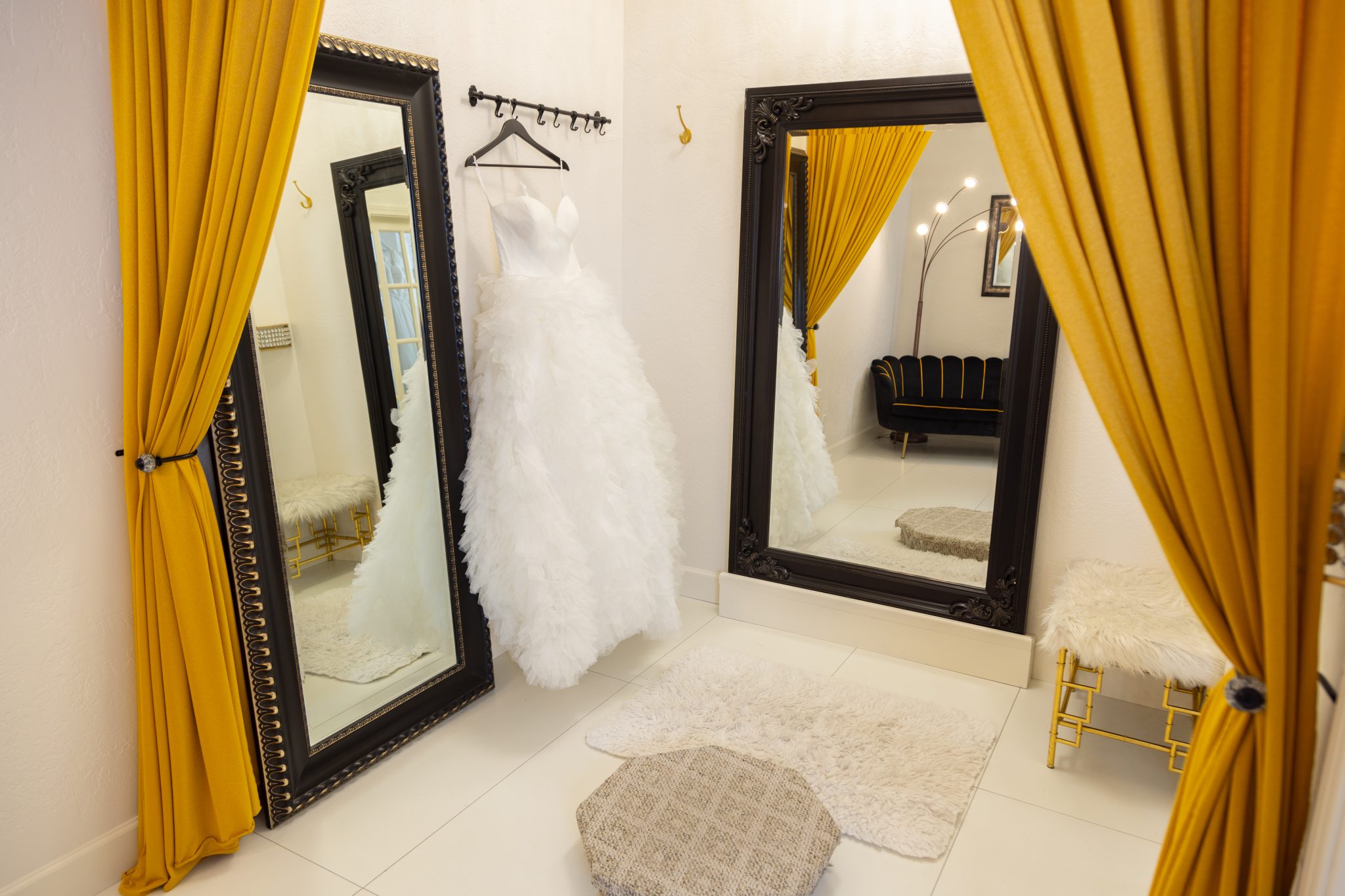 A fitting room of an elegant boutique with a layered tulle dress