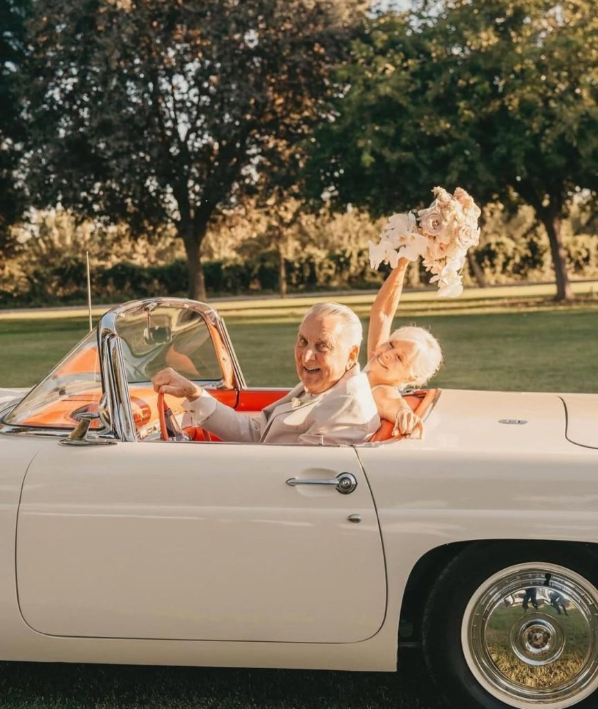 elderly newly weds in a convertible